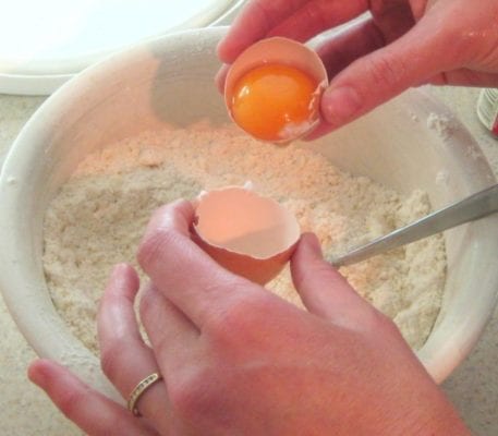 adding-the-egg-to-small-cake-