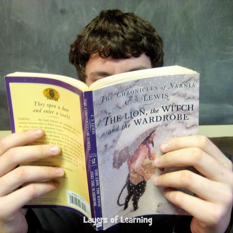 Boy reading The Lion, The Witch, and the Wardrobe