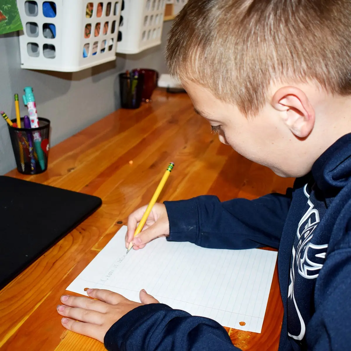Young man writing at a desk